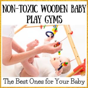 baby playing with wooden baby gym